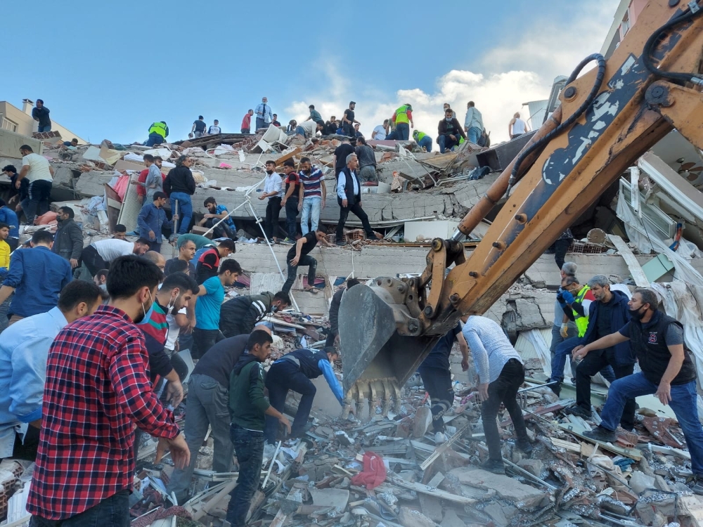 Locals and officials search for survivors at a collapsed building after a strong earthquake struck the Aegean Sea on Friday and was felt in both Greece and Turkey, where some buildings collapsed in the coastal province of Izmir, Turkey, October 30, 2020. 