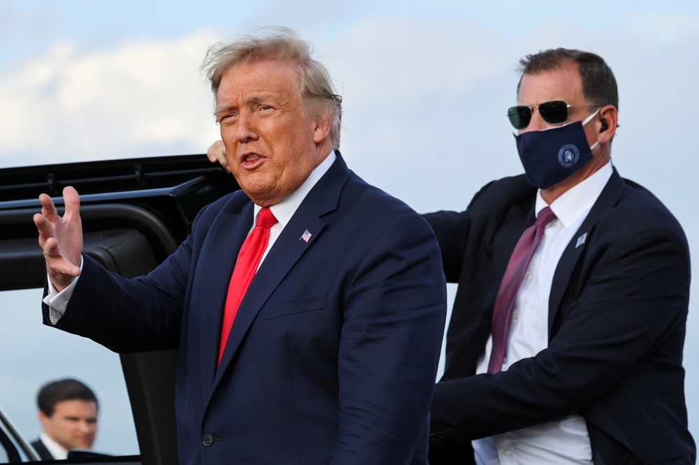 FILE PHOTO: U.S. President Donald Trump gestures as he prepares to get into a vehicle after arriving aboard Air Force One in Pope Field at Fort Bragg, North Carolina, U.S., October 29, 2020. REUTERS/Jonathan Ernst