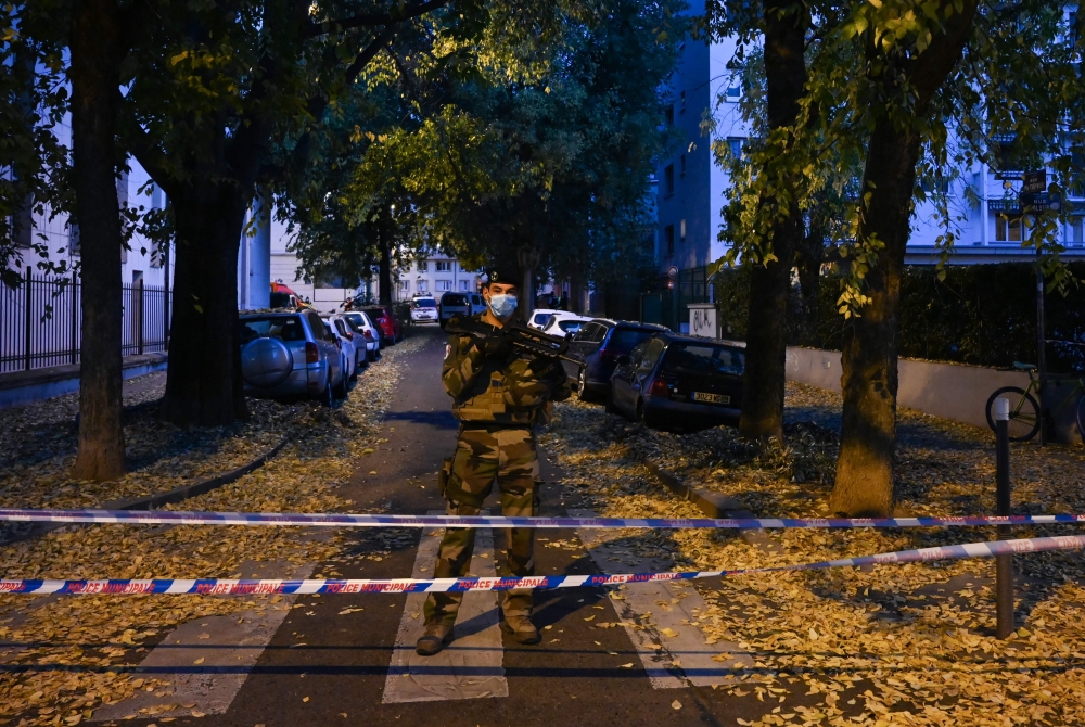 A French soldier stands behind a cordon on October 31, 2020 in Lyon near the scene where an attacker armed with a sawn-off shotgun wounded an Orthodox priest in a shooting before fleeing, said a police source.AFP / Philippe DESMAZE
