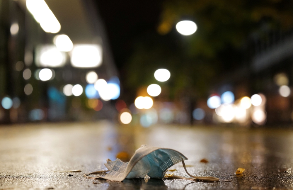A used protective mask is left in an pedestrian area as the spread of COVID-19 continues in Frankfurt, Germany, November 1, 2020, REUTERS/Kai Pfaffenbach