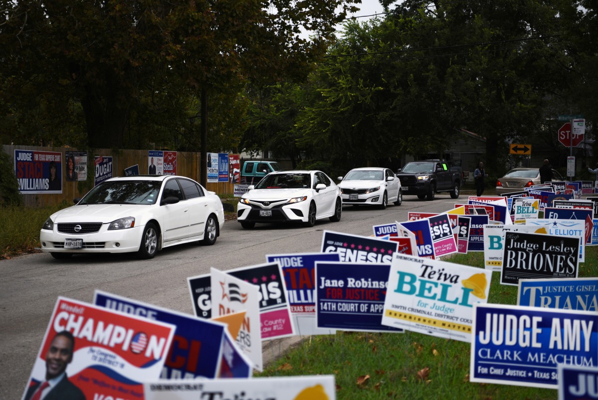 FILE PHOTO: A line of cars drive in for an event encouraging community members to vote in the upcoming presidential election at an early voting site in Houston, Texas, U.S., October 25, 2020. Picture taken October 25, 2020. REUTERS/Callaghan O'Hare/File P
