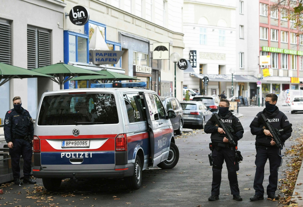 Policemen guard the area on November 3, 2020 close to a crime scene in Vienna after a shooting. A huge manhunt was under way Tuesday, November 3, 2020 after gunmen opened fire on November 2, 2020 at multiple locations across central Vienna, killing at lea