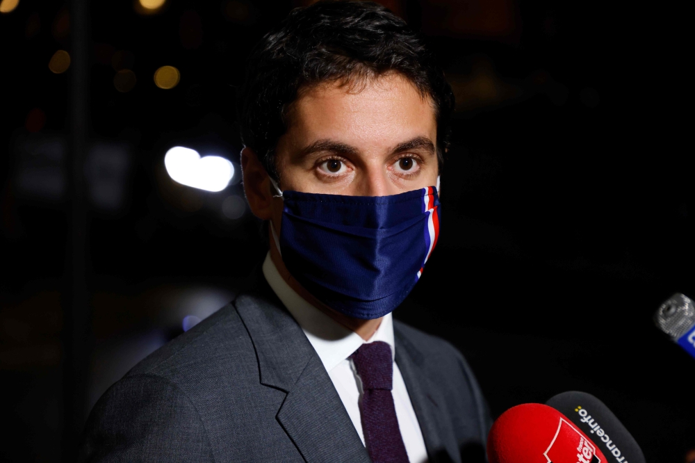 French Secretary of State and Government's spokesperson Gabriel Attal answers to media after an information meeting chaired by the French Prime minister with political party chiefs on October 27, 2020, in Paris, ahead of the probable announcement of tough