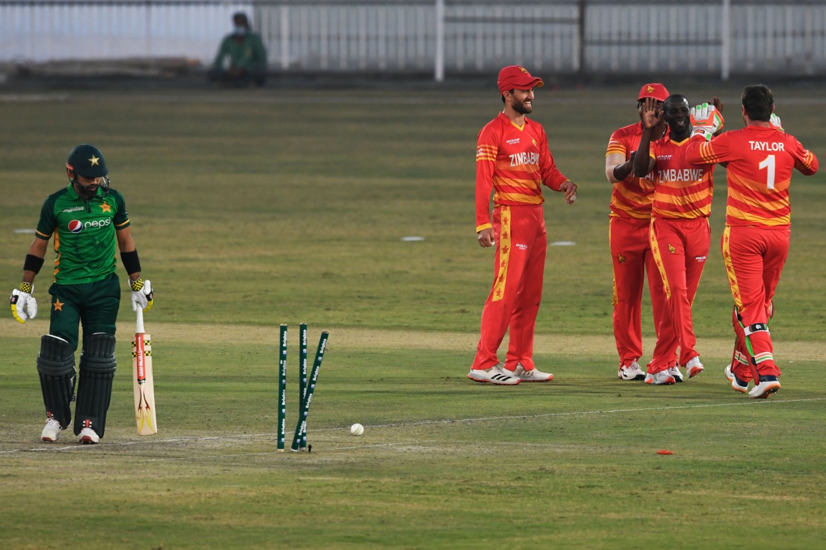 Zimbabwe's Donald Tiripano (2R) celebrates with teammates after taking the wicket of Pakistan's Mohammad Rizwan (L) during the third one-day international (ODI) cricket match between Pakistan and Zimbabwe at the Rawalpindi Cricket Stadium in Rawalpindi on