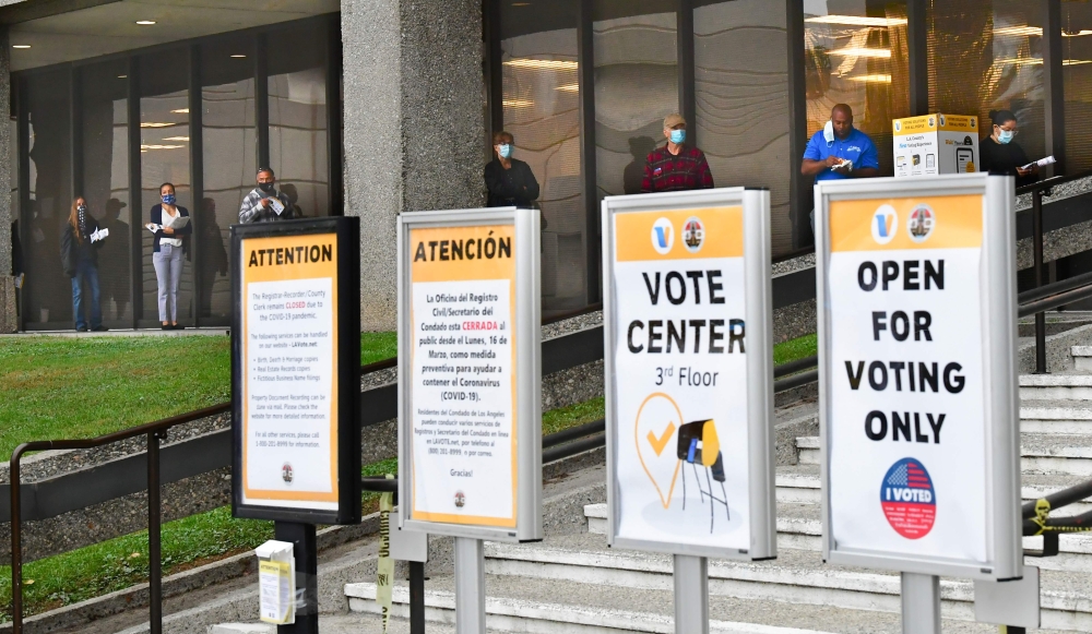Voters wait in line to cast their ballots at the Los Angeles County Registar in Norwalk, California on November 3, 2020 where people are voting in the 2020 US elections. Americans were voting on Tuesday under the shadow of a surging coronavirus pandemic t