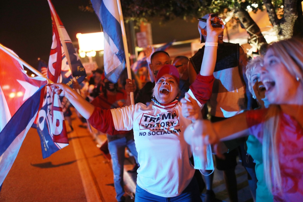 Supporters of U.S. President Donald Trump cheer outside of the Versailles restaurant as they await the results of the presidential election on November 03, 2020 in Miami, Florida. Joe Raedle/Getty Images/AFP