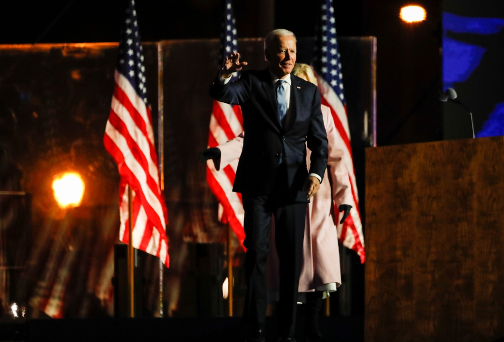 US Democratic presidential nominee and former Vice President Joe Biden wears a face mask as he reacts next to his wife Jill following early results from the 2020 U.S. presidential election in Wilmington, Delaware, U.S., November 4, 2020. Reuters/Mike Sega
