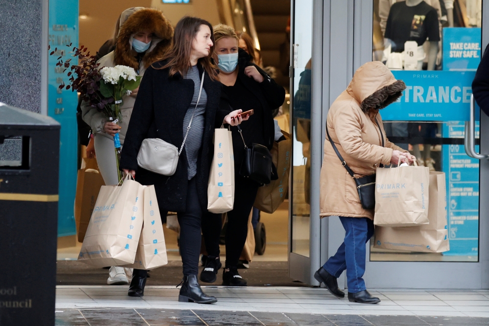 Shoppers are seen leaving a Primark store with bags, after new nationwide restrictions were announced during the coronavirus disease (COVID-19) outbreak in Liverpool, Britain, November 4, 2020. Reuters/Phil Noble