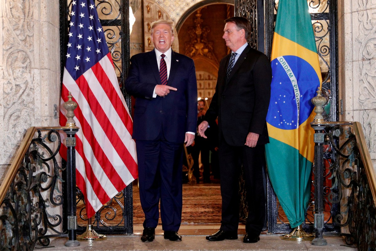 FILE PHOTO: U.S. President Donald Trump hosts a photo-op with Brazilian President Jair Bolsonaro before attending a working dinner at the Mar-a-Lago resort in Palm Beach, Florida, U.S., March 7, 2020. REUTERS/Tom Brenner/File Photo
