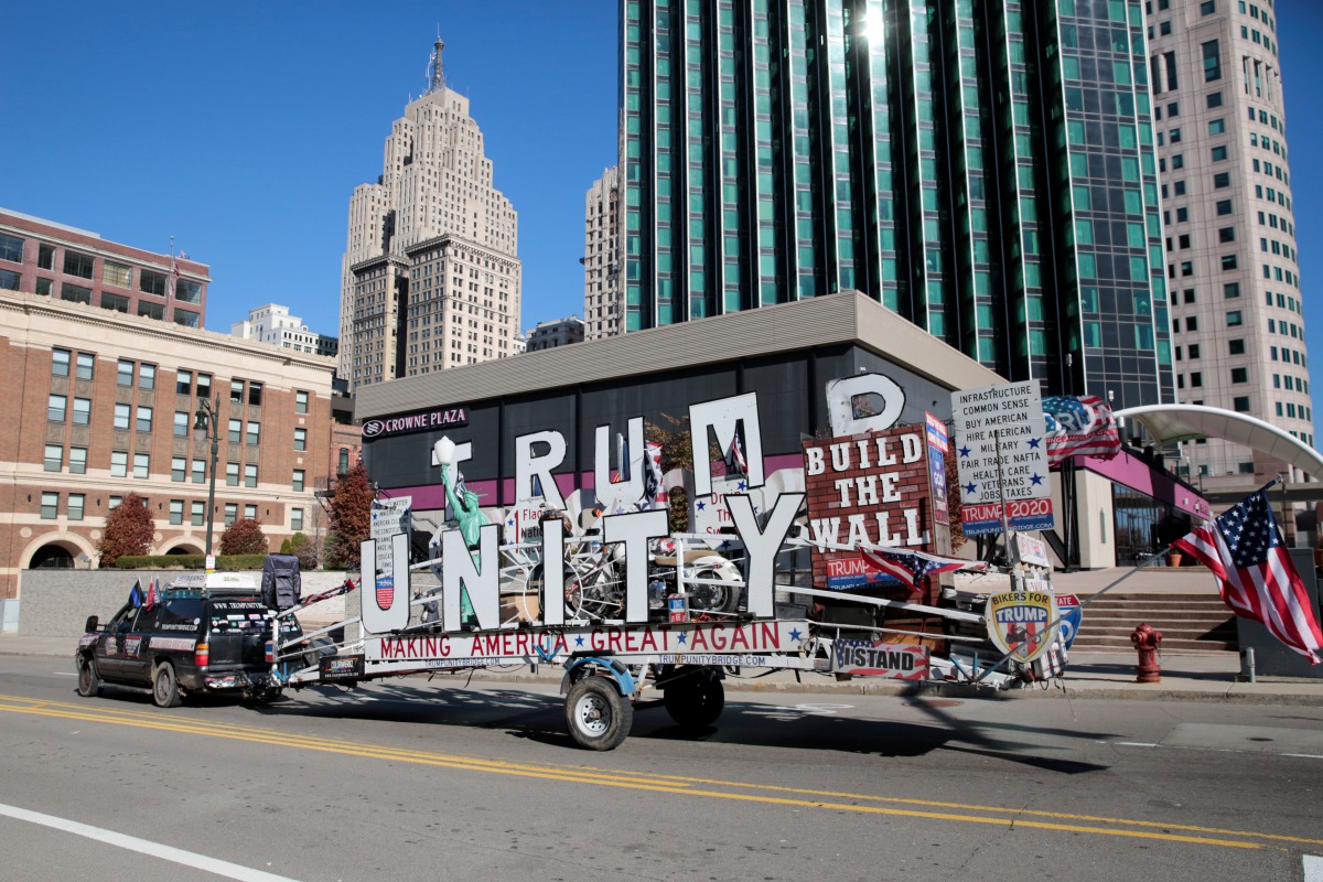 A supporter of U.S. President Donald Trump talks through a loudspeaker while driving his Trump Unity Bridge outside the TCF Center where poll workers are tabulating ballots after Election Day in Detroit, Michigan U.S., November 4, 2020. REUTERS/Rebecca Co