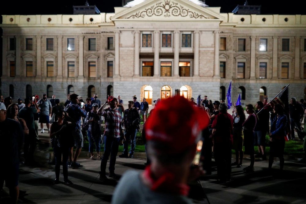 Supporters of U.S. President Donald Trump gather in front of the Arizona State Capitol Building to protest about the early results of the 2020 presidential election, in Phoenix, Arizona November 4, 2020. REUTERS/Edgard Garrido