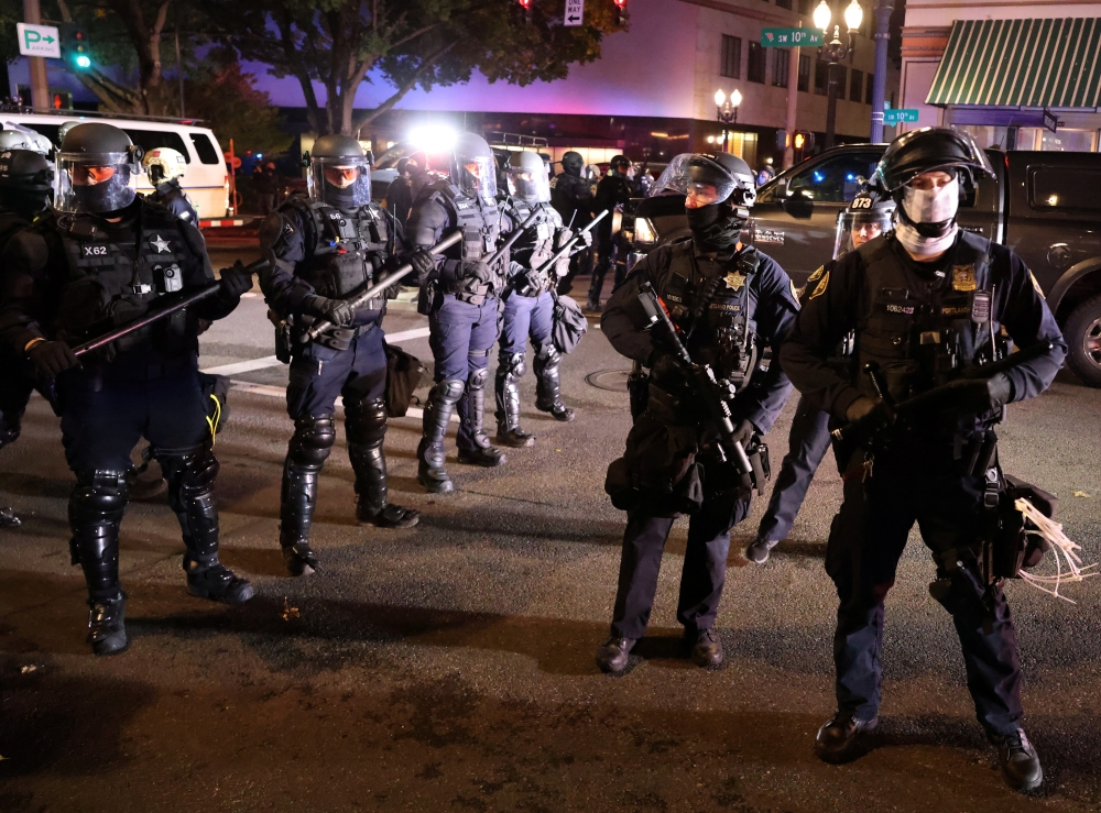 Police stand in front of demonstrators during a protest the day after Election Day in Portland, Oregon, U.S., November 4, 2020. REUTERS/Goran Tomasevic