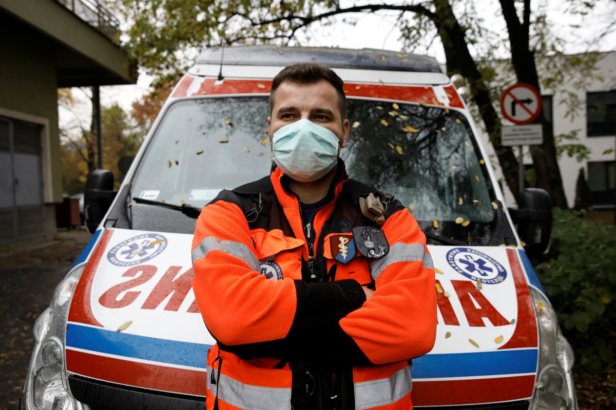 Paramedic Marcin Serwach, 35, attends an interview with Reuters amid the global outbreak of the coronavirus disease (COVID-19), at a cemetery in Warsaw, Poland, November 4, 2020. REUTERS/Kacper Pempel
