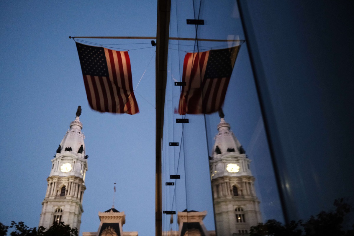 PHILADELPHIA, PENNSYLVANIA - NOVEMBER 04: The American flag hangs from a building near Philadelphia City Hall on November 04, 2020 in Philadelphia, Pennsylvania. Spencer Platt/Getty Images/AFP