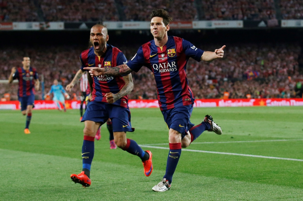 Lionel Messi celebrates with Dani Alves after scoring the first goal for Barcelona Reuters / Albert Gea/File Photo