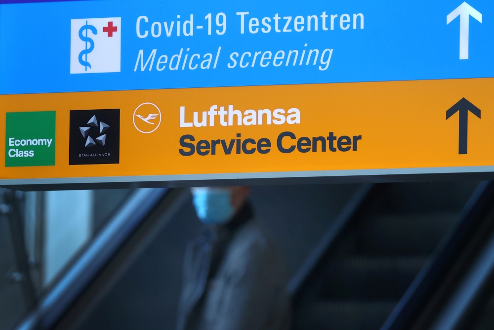 Signs lead the way towards the COVID-19 testing centre and the service desk of German air carrier Lufthansa at Frankfurt Airport as the spread of the coronavirus disease (COVID-19) continues in Frankfurt, Germany, November 6, 2020. REUTERS/Kai Pfaffenbach
