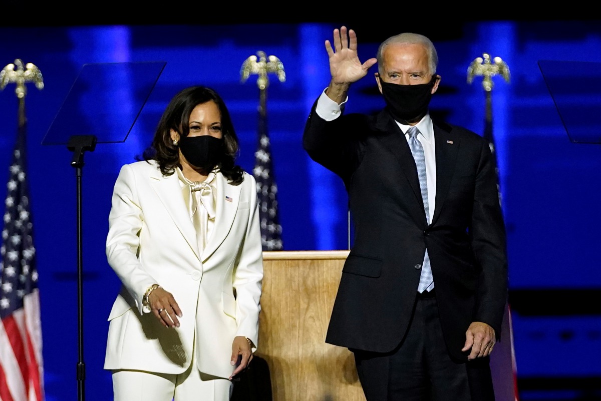 Democratic vice-presidential nominee Kamala Harris and Democratic 2020 U.S. presidential nominee Joe Biden greet supporters at an election rally, after news media announced that Biden has won the 2020 U.S. presidential election, in Wilmington, Delaware, U