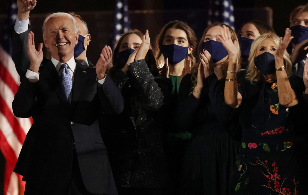 Democratic 2020 US presidential nominee Joe Biden and his family celebrate onstage at his election rally, after the news media announced that Biden has won the 2020 U.S. presidential election over President Donald Trump, in Wilmington, Delaware, U.S., Nov
