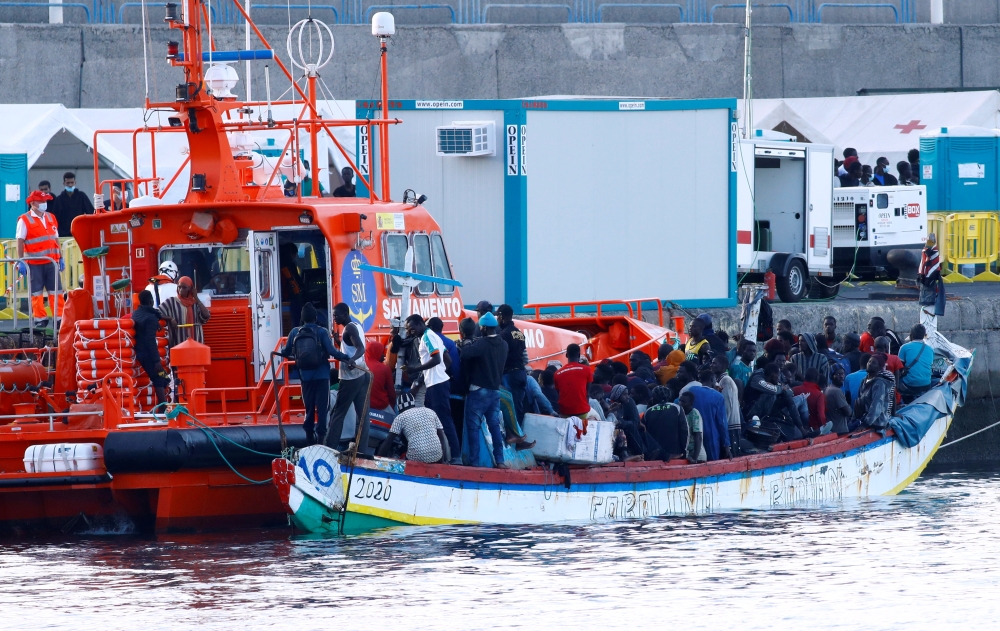 One hundred and twenty nine migrants wait to disembark as they are rescued by a Spanish coast guard vessel in the port of Arguineguin, after dozens of them arrived to the south part of the island of Gran Canaria, Spain, November 2, 2020. REUTERS/Borja Sua