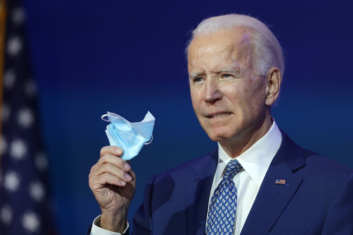 WILMINGTON, DELAWARE - NOVEMBER 09: U.S. President-elect Joe Biden holds a protective mask as he speaks to the media after receiving a briefing from the transition COVID-19 advisory board on November 09, 2020 at the Queen Theater in Wilmington, Delaware. 