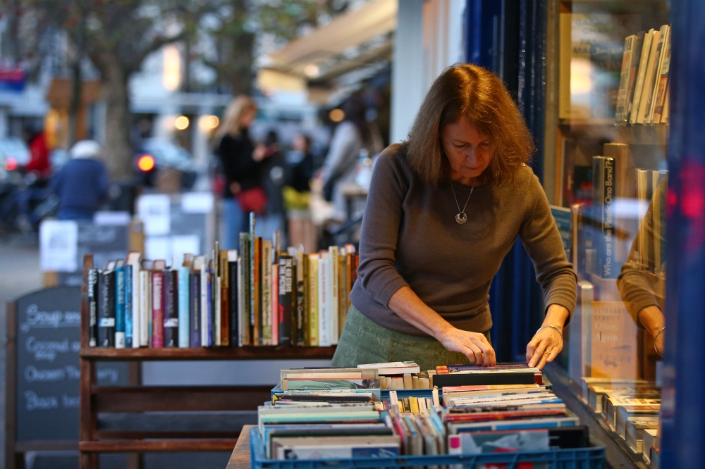 Jessica Graham, owner of independent book shop Primrose Hill Books, poses for a photograph in west London on November 6, 2020. [AFP/ Hollie Adams] 