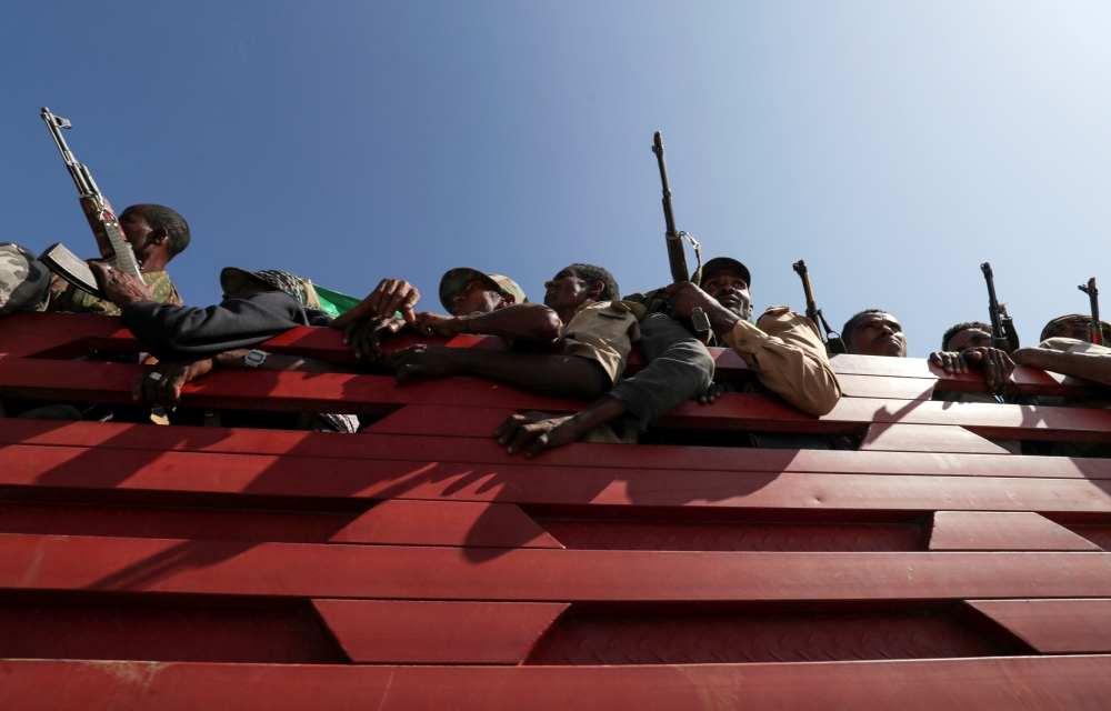 FILE PHOTO: Members of Amhara region militias ride on their truck as they head to the mission to face the Tigray People's Liberation Front (TPLF), in Sanja, Amhara region near a border with Tigray, Ethiopia November 9, 2020. REUTERS/Tiksa Negeri