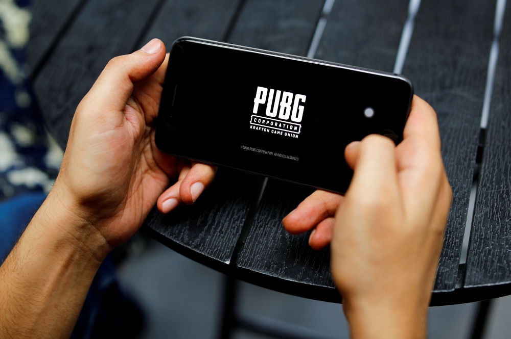A boy plays Tencent Holdings' PUBG videogame on his mobile phone at a cafe in New Delhi, India, September 3, 2020. REUTERS/Adnan Abidi/File Photo