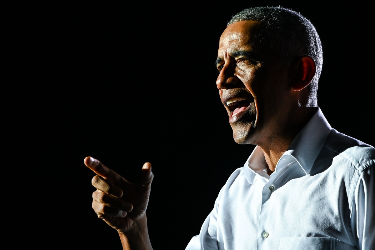 (FILES) In this file photo taken on November 02, 2020, former US President Barack Obama speaks at a drive-in rally as he campaigns for Democratic presidential candidate former Vice President Joe Biden in Miami, Florida. / AFP / CHANDAN KHANNA
