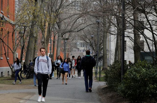 FILE PHOTO: Students and pedestrians walk through the Yard at Harvard University in Cambridge, Massachusetts, U.S., March 10, 2020. REUTERS/Brian Snyder/File Photo
