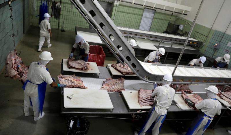 FILE PHOTO: Employees work at the assembly line of jerked beef at a plant of JBS S.A, the world's largest beef producer, in Santana de Parnaiba, Brazil December 19, 2017. REUTERS/Paulo Whitaker
