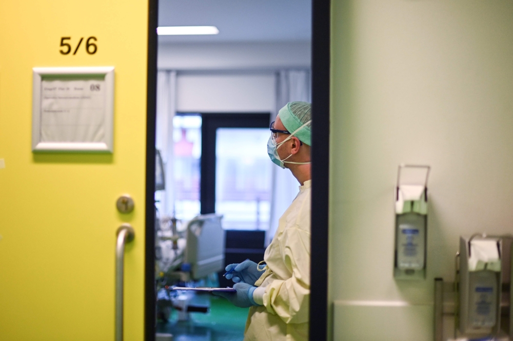 A doctor takes care of a Covid-19 patient in the intensive care unit at the University Hospital of Aachen, western Germany, on November 10, 2020 during the novel coronavirus (Covid-19) pandemic. AFP / Ina Fassbender 