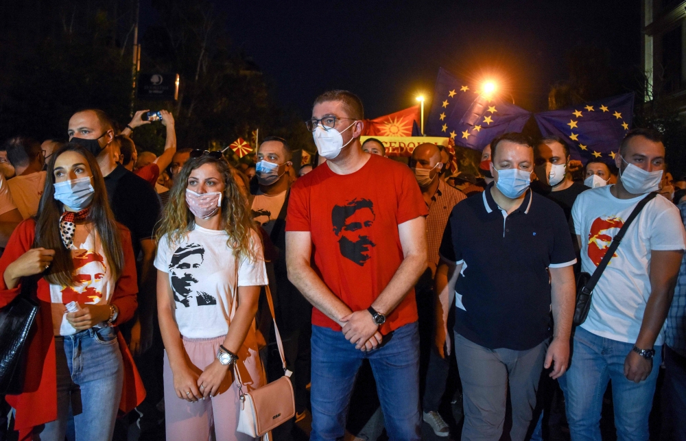 This photograph taken on September 15, 2020, shows VMRO DPMNE opposition leader Hristijan Mickovski (C) wearing a T-shirt with an image of revolutionary figure Goce Delchev, as he stands with others during an anti-government protest in Skopje. AFP / Rober