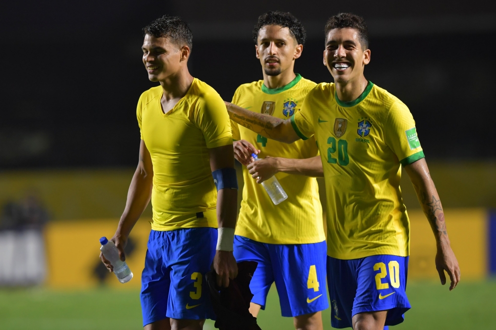 (L-R) Brazil's Thiago Silva, Marquinhos and Roberto Firmino celebrate after defeating Venezuela 1-0 in their closed-door 2022 FIFA World Cup South American qualifier football match at Morumbi Stadium in Sao Paulo, Brazil, on November 13, 2020. AFP / Pool 