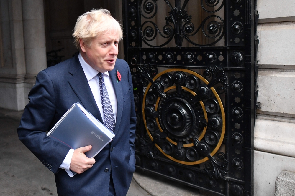 (FILES) In this file photo taken n November 10, 2020, Britain's Prime Minister Boris Johnson arrives back at Downing Street in London after chairing the weekly cabinet meeting held at the nearby Foreign, Commonwealth and Development Office. AFP / Justin T