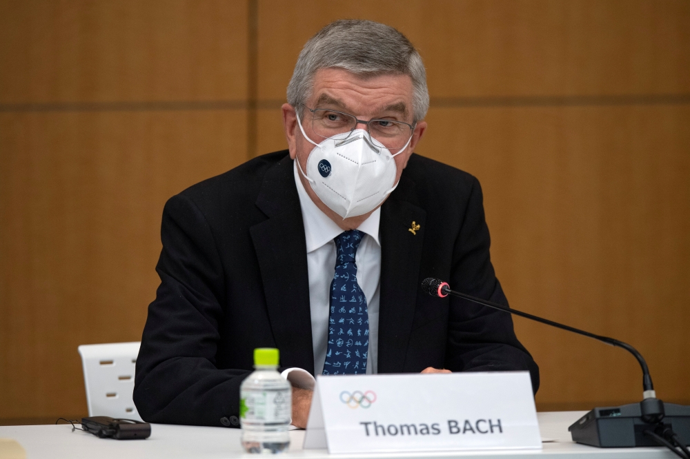 International Olympic Committee President Thomas Bach wears a face mask as he speaks during a news conference in Tokyo, Japan November 16, 2020. Carl Court/Pool via REUTERS