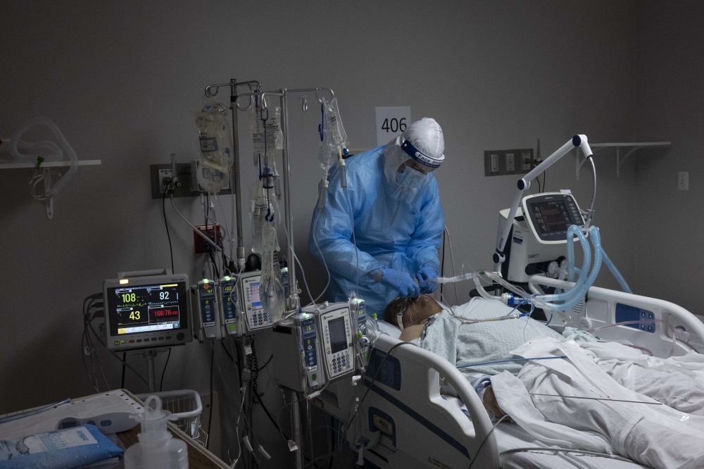 A medical staff member treats a patient suffering from coronavirus in the COVID-19 intensive care unit (ICU) at United Memorial Medical Center on November 16, 2020 in Houston, Texas. Texas has recorded more than 1.1 million cases of the disease, with more