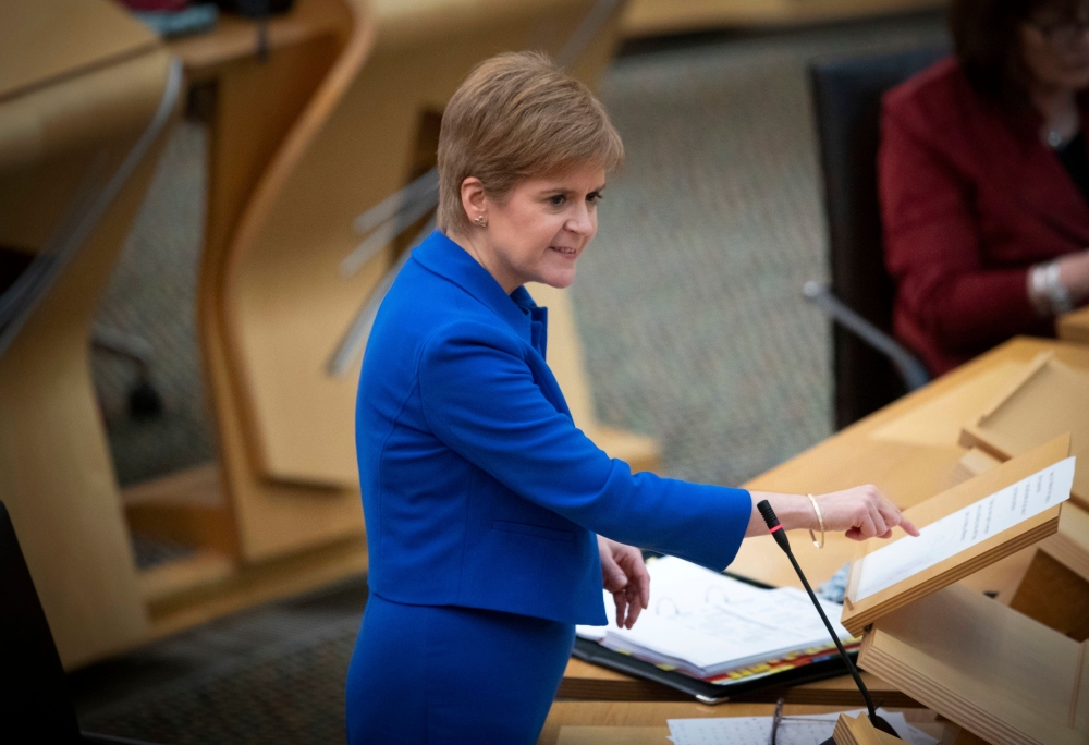 Scotland's First Minister Nicola Sturgeon gestures during the First Minister's Questions session at the Scottish Parliament in Holyrood, Edinburgh on November 12, 2020. / AFP / POOL / Jane Barlow