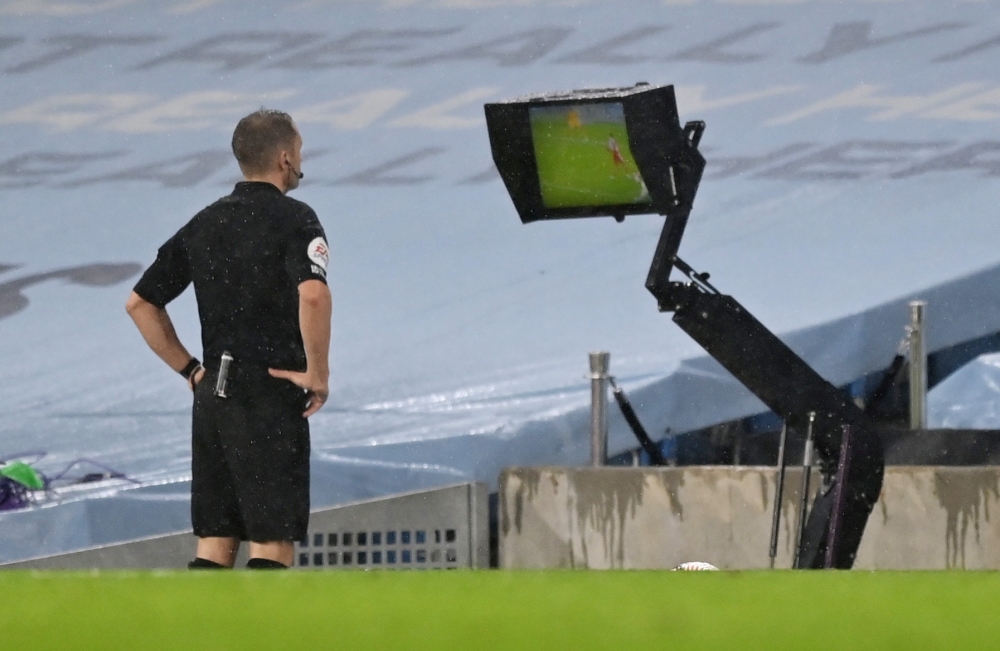 Referee Craig Pawson refers to VAR before awarding a penalty to Manchester City Pool via REUTERS/Shaun Botterill 