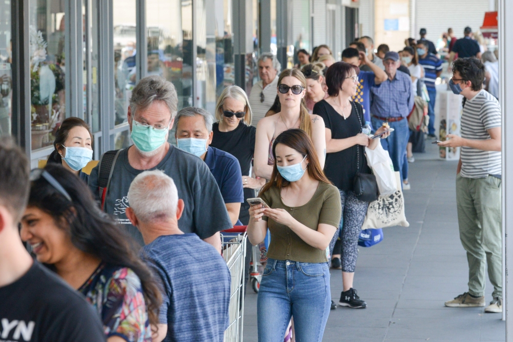 People queue at a supermarket after the South Australian state government announced a six-day lockdown because of the Covid-19 corona virus out break in Adelaide on November 18, 2020. / AFP / Brenton EDWARDS