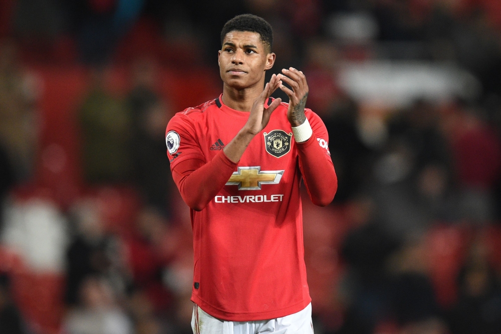 (Files) Manchester United's English striker Marcus Rashford applauds supporters on the pitch after the English Premier League football match between Manchester United and Aston Villa at Old Trafford in Manchester, north west England. AFP / Oli Scarff  