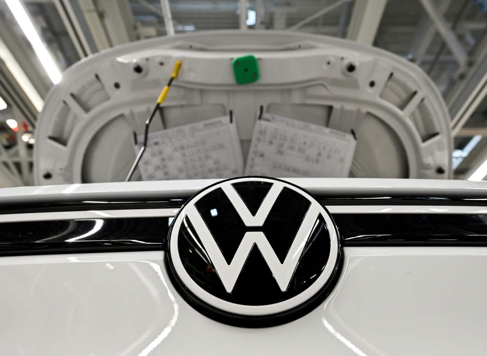 A car stands at the production line for the electric Volkswagen cars, model ID.3 and model ID. 4, in Zwickau, Germany, September 18, 2020. Picture taken September 18. REUTERS/Matthias Rietschel/File Photo