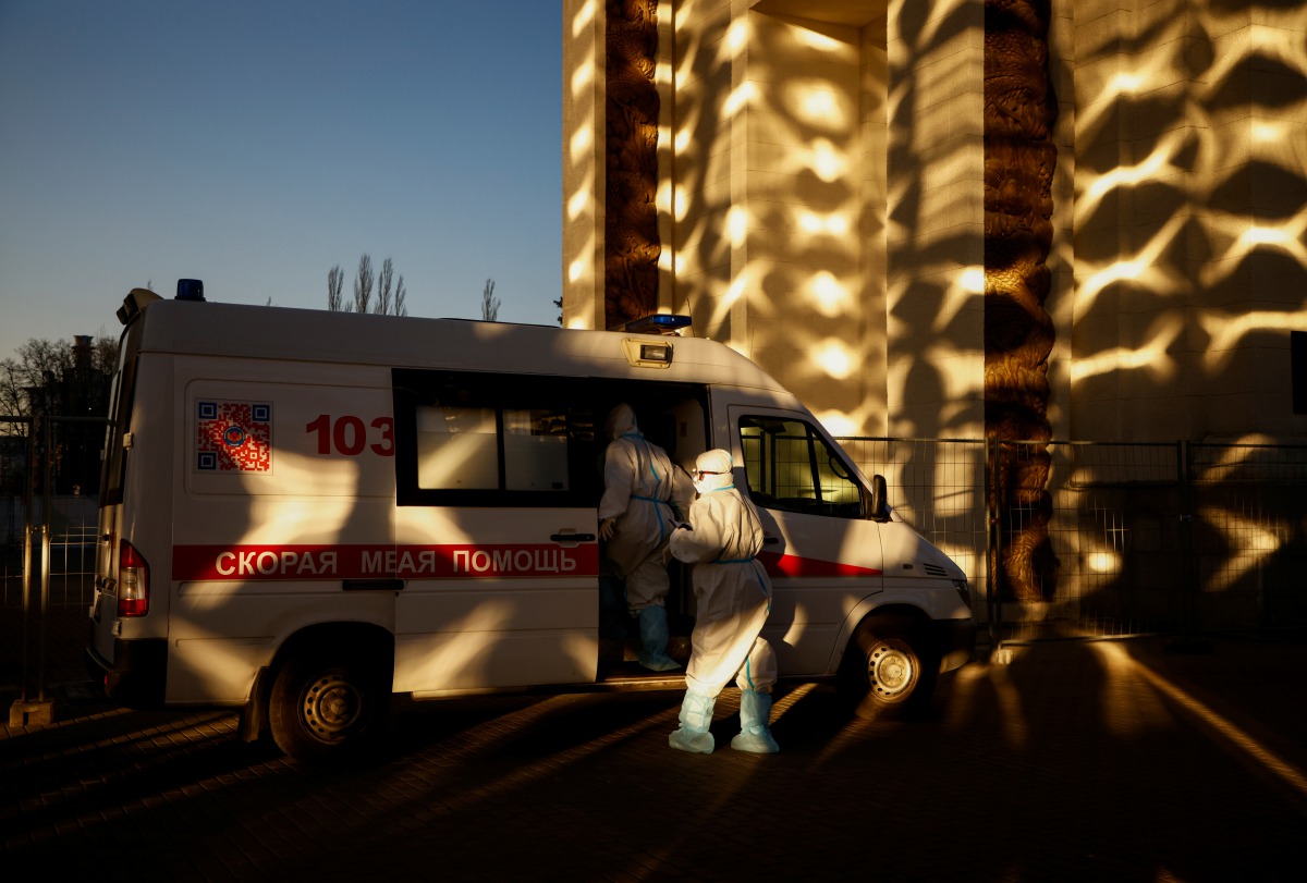 Medical specialists get into an ambulance outside a pavilion of the Exhibition of Achievements of National Economy (VDNH), which was converted into a temporary hospital for people suffering from the coronavirus disease (COVID-19), in Moscow, Russia Novemb