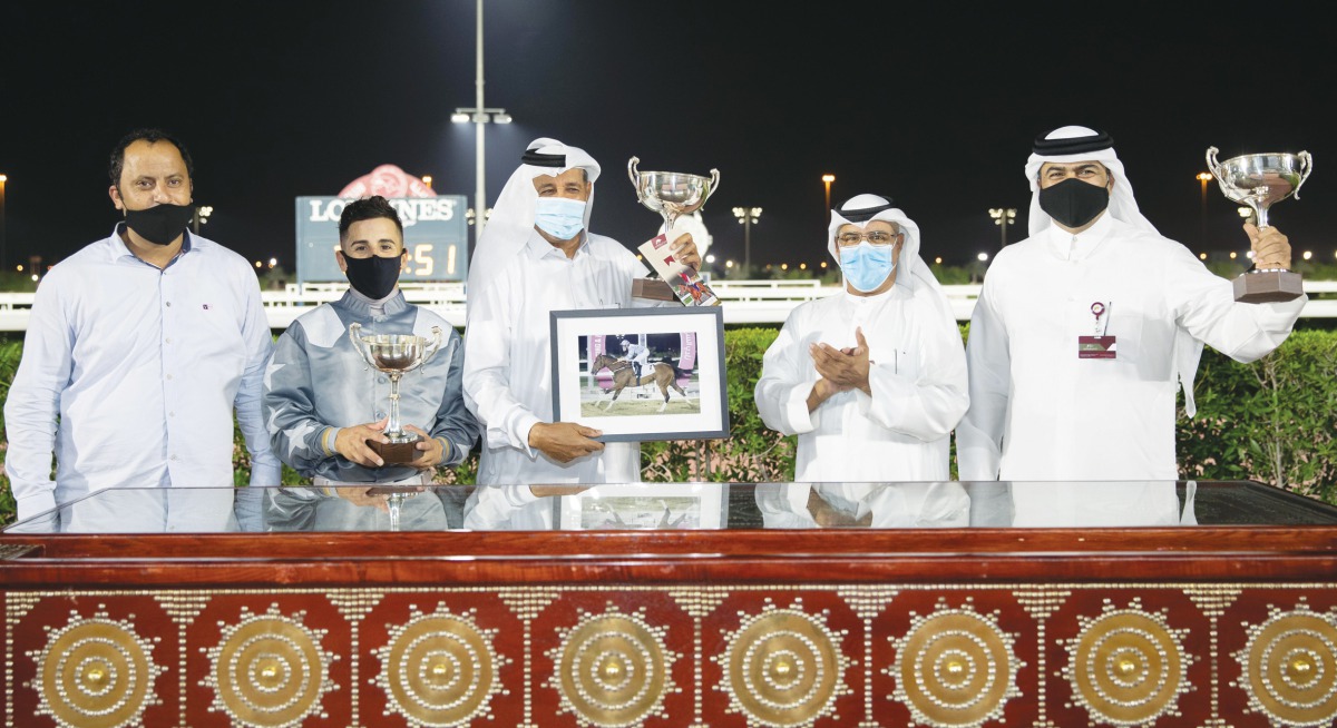 Jockey Soufiane Saadi is seen with his team after he won the Muraikh Cup with X Force in race meeting 11 of the new horse racing season at Qatar Racing and Equestrian Club. 