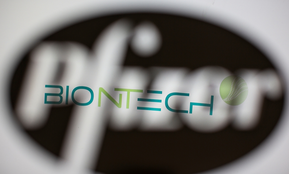 Biontech's logo is seen through a 3D-printed Pfizer logo in this illustration taken November 10, 2020. REUTERS/Dado Ruvic/Illustration/File Photo