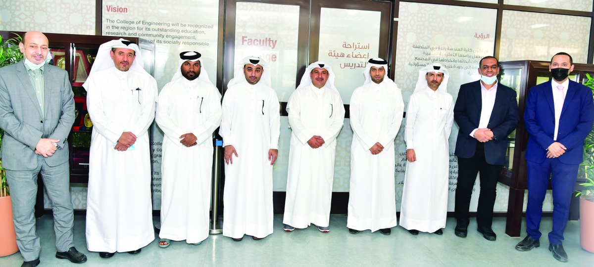 Officials of QU and Aryan Properties pose after signing the MoU.