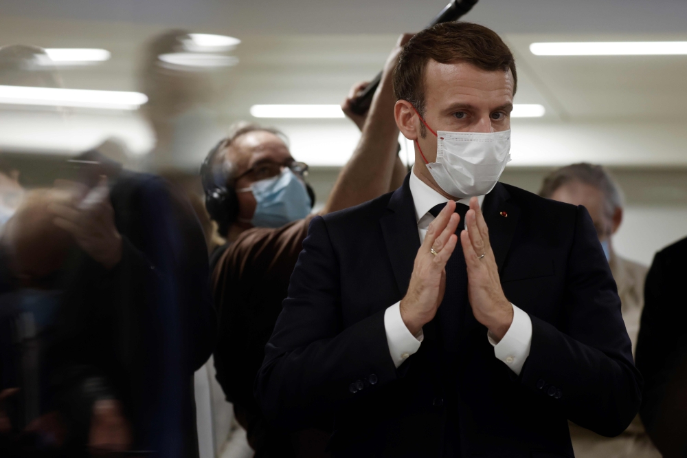 French President Emmanuel Macron speaks to volunteers during the 2020 Phoneton, an annual fundraising operation organised by the Hayastan All-Armenian Fund's French affiliate (Fonds Armenien de France) for the development of Armenia and Artsakh, on Novemb