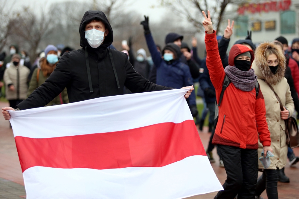 Opposition supporters parade through the streets during a rally to protest against police violence and Belarus presidential election results in Minsk on November 22, 2020. AFP 