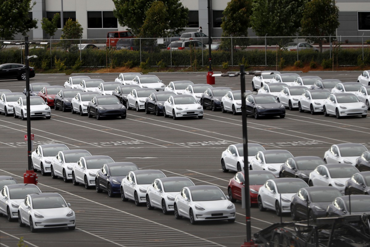 FILE PHOTO: New Tesla electric vehicles are seen in a lot at Tesla's primary vehicle factory after CEO Elon Musk announced he was defying local officials' coronavirus disease (COVID-19) restrictions by reopening the plant in Fremont, California, U.S. May 