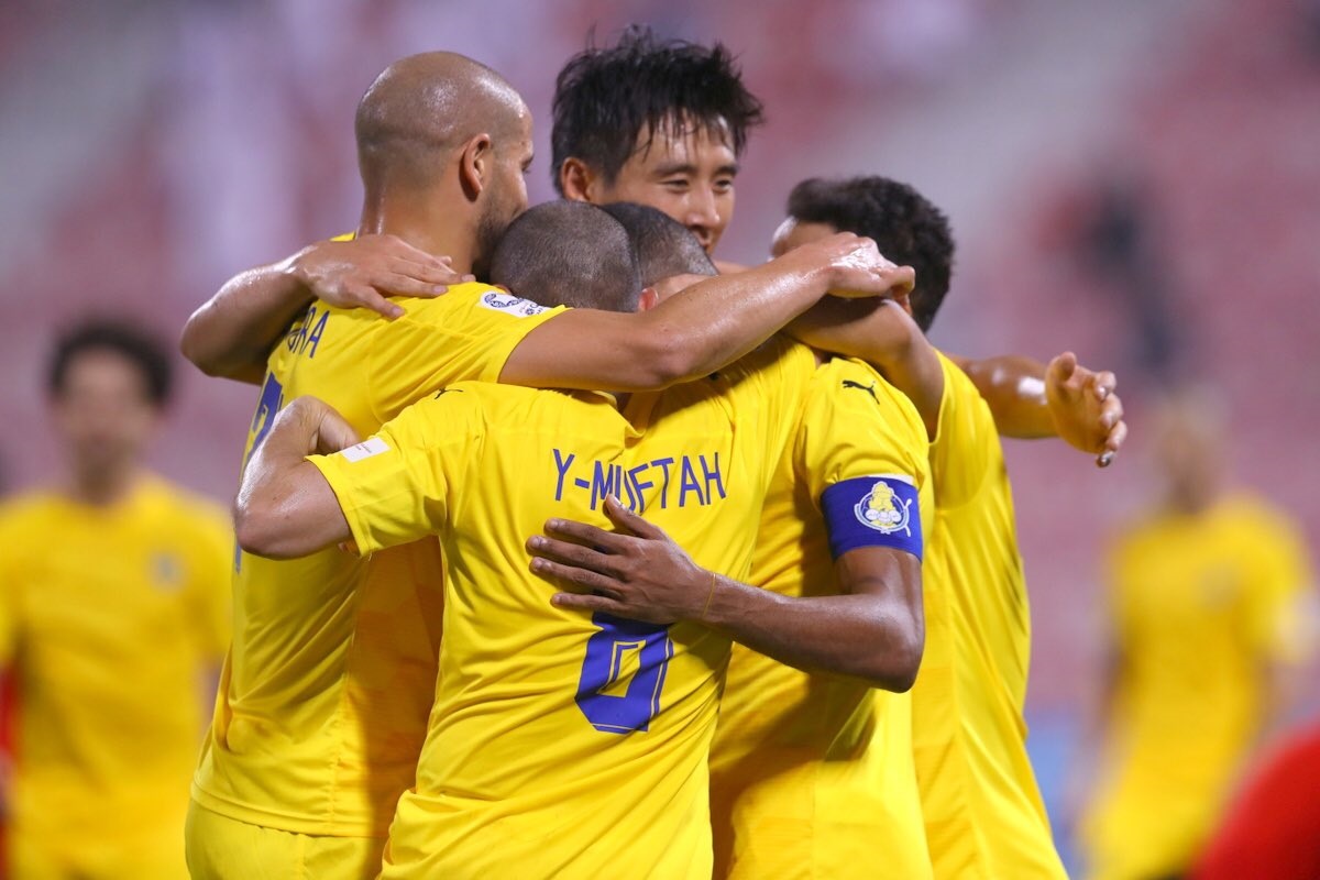 Al Gharafa players celebrate.