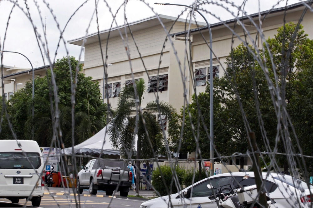 Exterior of workers' hostel for Top Glove, world's largest glove maker, is seen through barricade amid the coronavirus disease (COVID-19) outbreak in Meru, Selangor state, Malaysia, November 24, 2020. REUTERS/Ebrahim Harris